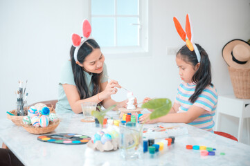 mother and child family making waster egg at home happy and fun together in holiday