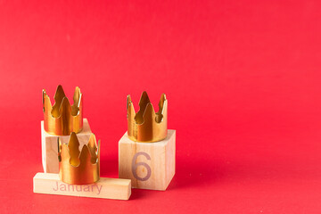 Three gold crowns on red background with 6 Junuary date  for Dia de Reyes Magos day ( Three Wise...
