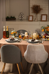 Table set with beautiful autumn decor for festive dinner in room