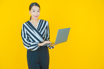 Portrait beautiful young asian woman smile with computer laptop