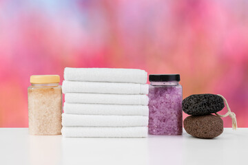 Various spa beauty threatment products and towels against blurred background
