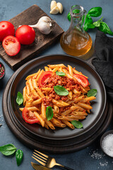 Traditional pasta with bolognese sauce on a graphite background. Italian cuisine.