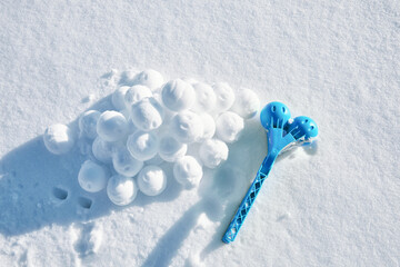 Children toy is a tool for modeling snowballs from snow. Blue color plastic device. Winter outdoor kids games. Active leisure gift. Snowy background. Copy space. Banner. Ice forceps. New year time