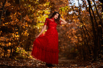 Woman in red dress in the oak forest, full body