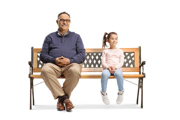 Mature man and a little girl sitting on a bench and looking at camera