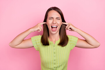 Fototapeta premium Photo of young girl cover ears fingers shout irritated mad crazy shirt top isolated over pink color background