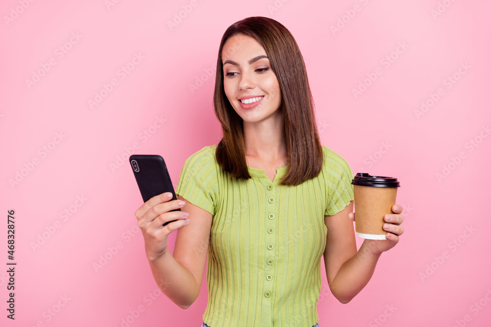 Sticker photo of cute brunette millennial lady drink coffee look telephone wear green t-shirt isolated on pi