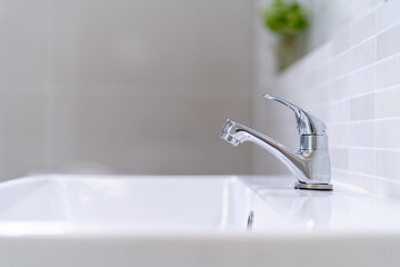 The bathroom faucet is turned off to save water energy and protect the environment. world...