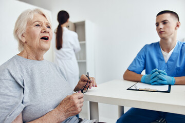 old woman at the doctor's and nurse's appointments professional advice