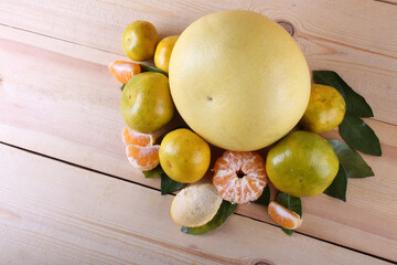 Pomelo and mandarin oranges on table