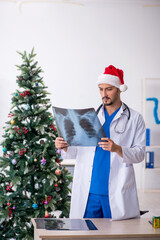 Young male doctor celebrating Christmas at the hospital