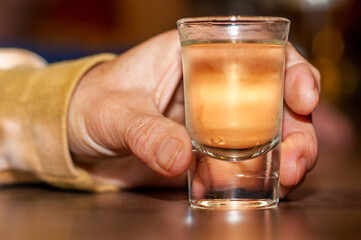 Hand with a glass of alcohol
