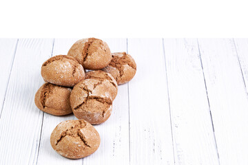 Group of rye bread buns on a white wooden board. Food concept