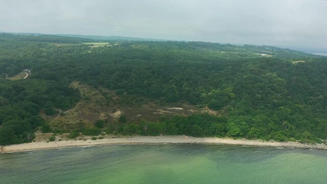 Aerial view of shore along forest, Stenshuvud natinal park in southern Sweden