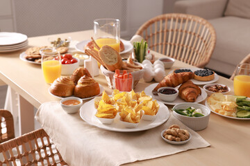Dishes with different food on table in room. Luxury brunch