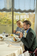 Attractive couple having lunch in hotel restaurant