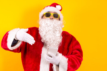 santa claus showing mobile phone isolated