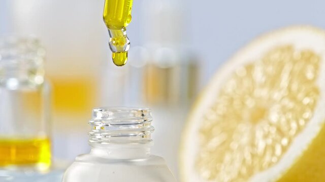 Super Slow Motion Shot of Oily Lemon Essence Drop from Pipette into Phial at 1000fps.