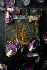 Fresh cabbage. Fresh sliced purple cabbage. On a black stone background.