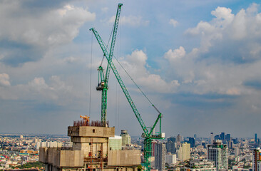 Construction crane or climbing crane on a roof of a high-rise project to be completed