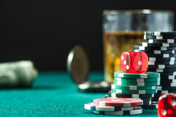 Poker Chips Stacks Pile and Dices on Green Casino Table. Gambling and Betting Background