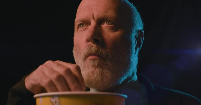 Focused Man Watching A Suspense Movie At The Cinema