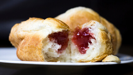 Croissants with strawberry jam so close