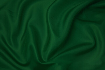 Texture, background, pattern. Texture of green silk fabric. Beautiful emerald green soft silk...