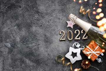 happy new year 2022  background new year holidays card with bright lights,gifts and bottle of...