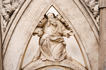 Sculpture of a man with a beard on the facade of the Duomo. Italy, Milan