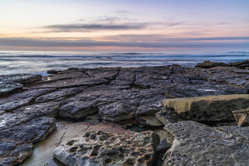 Fototapeta na wymiar Sunrise seascape with rocky foreground