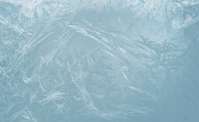 Winter blue ice frost texture background. Ice on a window, background.Abstract background of ice structure. Abstract frosty pattern on glass.  Frosted glass texture. Blue foil freeze gradient texture 