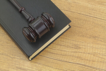 Judge gavel and legal book on wooden table. Law and justice concept, copy space for text.