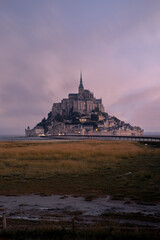 Obraz premium View of famous Mont Saint Michel tidal island at a beautiful sunrise time in Normandy, Northern France
