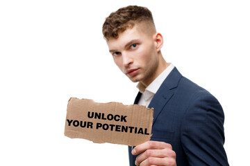 A businessman shows an inscription: UNLOCK YOUR POTENTIAL