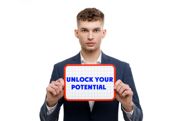 A businessman shows an inscription: UNLOCK YOUR POTENTIAL