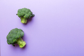 Top view fresh green broccoli vegetable on Colored background. Broccoli cabbage head Healthy or vegetarian food concept. Flat lay. Copy space
