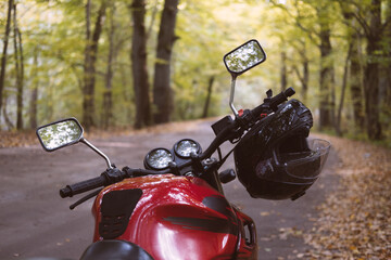 motorcycle with helmet in the autumn forest close up