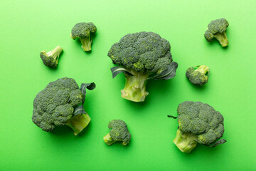green fresh broccoli background close up on colored table. Vegetables for diet and healthy eating. Organic food