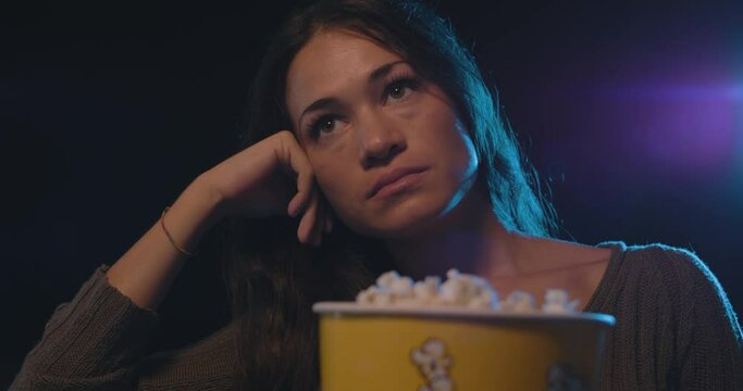 Woman watching a boring movie at the cinema