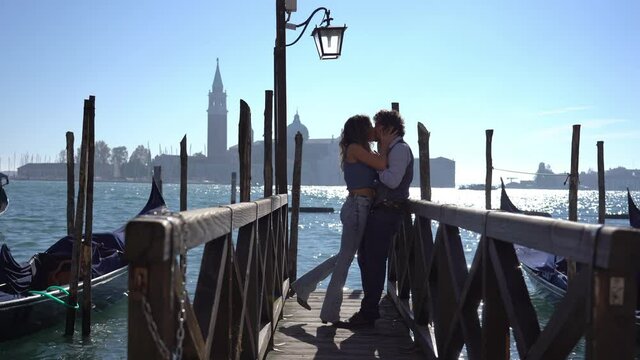 Italy - 40-year-old man and girlfriend on a love journey in Venice - Marriage proposal with ring and kiss in the city of love - request to get married on a wooden bridge in the Venice lagoon