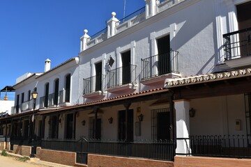 
White houses with typical Andalusian balconies in the town of El Rocío, in Huelva, Spain.