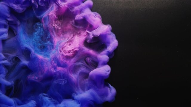 Paint water blast. Logo reveal. Ink drop. Color fume explosion. Iridescent fluorescent pink blue purple smoke cloud animation on black glitter dust copy space abstract background.