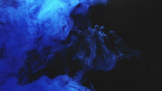 Color smoke flow. Transition effect. Glowing mist animation. Night sky dream. Blue vapor cloud motion on glitter dust particles black abstract background.