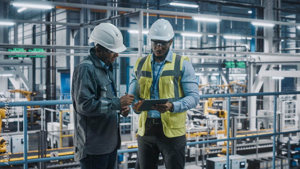 Poster multiethnic manager and african american car factory engineer in uniform using tablet computer. auto