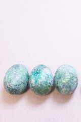 Symbol of the Easter holidays, beautifully colored eggs. Modern technique of applying paint to shell of natural chicken eggs. Vertical banner, copy space. Easter sale, idea how to paint eggs concept.