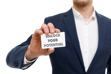 A businessman shows an inscription: UNLOCK YOUR POTENTIAL