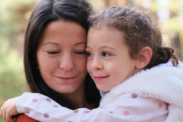 Mother and child in the forest exploring the nature having fun together smiling and laughing, true love emotion