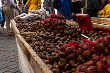 Fototapeta premium Close-up of many chestnuts, displayed at a street market selling local products. Porreres, island of Mallorca, Spain