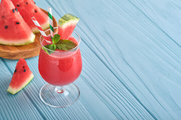 Watermelon cocktail with mint and ice. Summer refreshing drinks in glasses on blue wooden table. Concept of healthy summer eating.